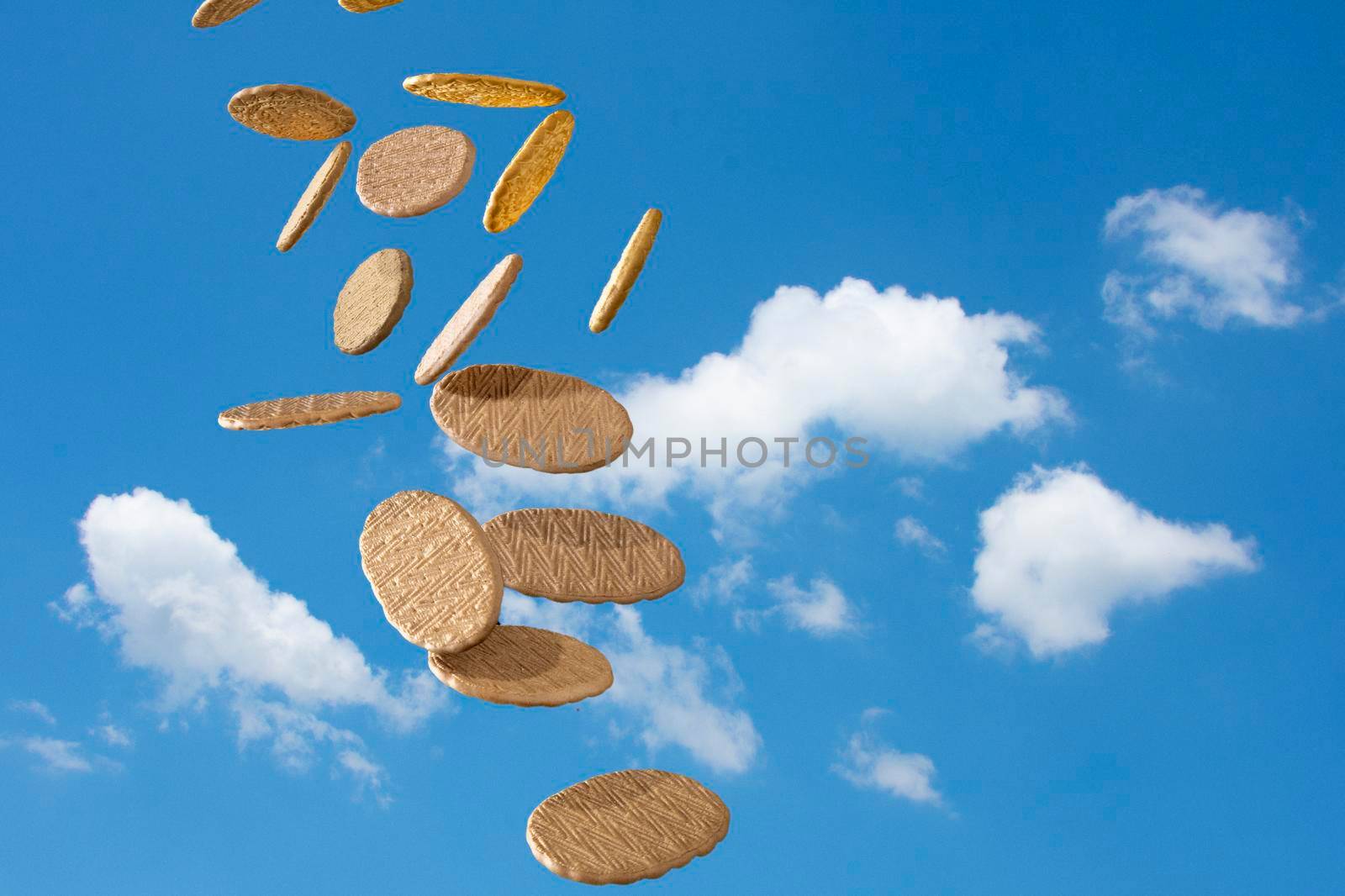 Fragrant, delicious biscuits fly against a blue sky with white clouds