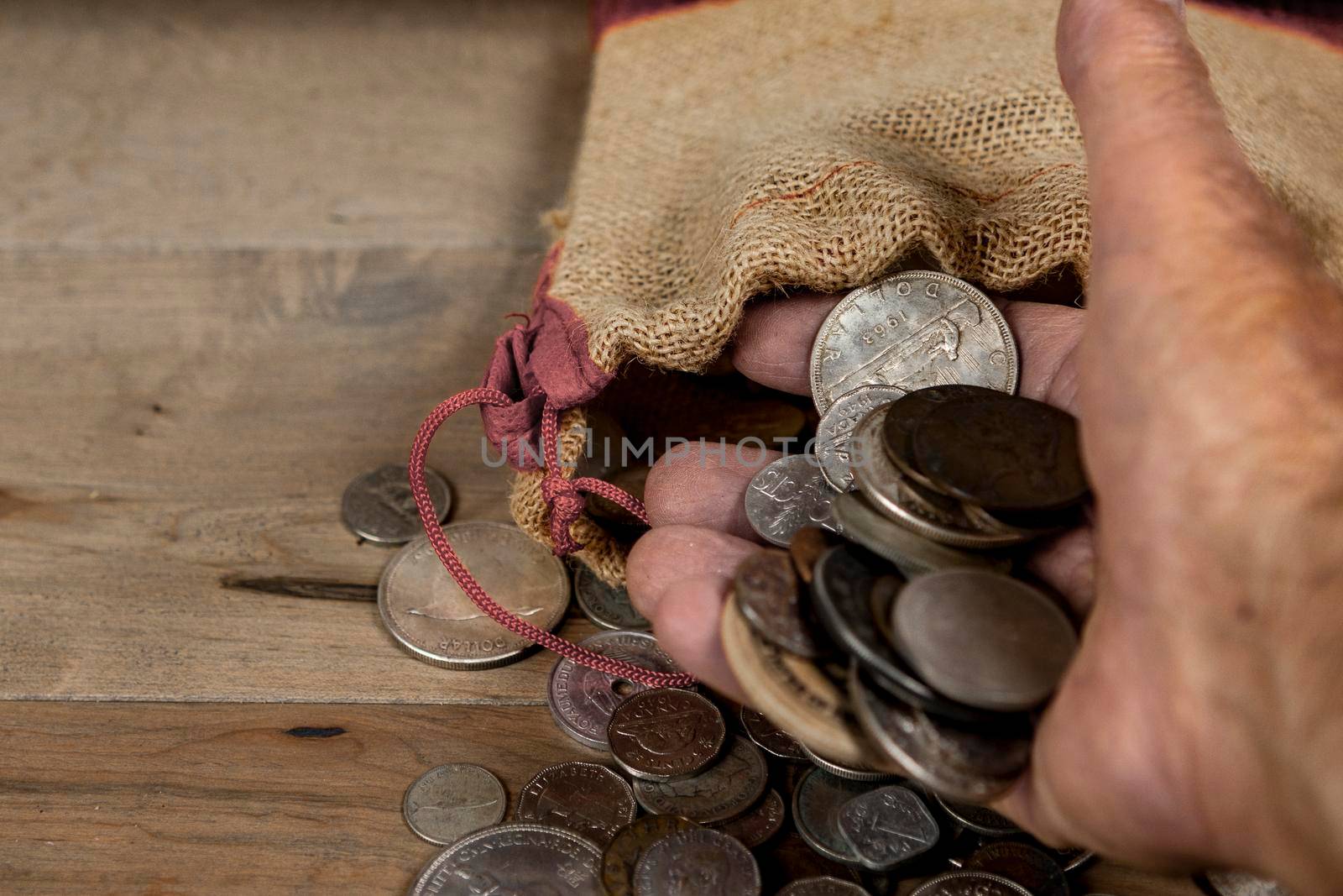 Coins taken from a small bag lie in the palm of your hand