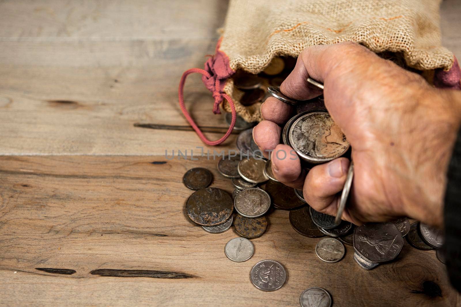Old coins clenched in a fist by ben44