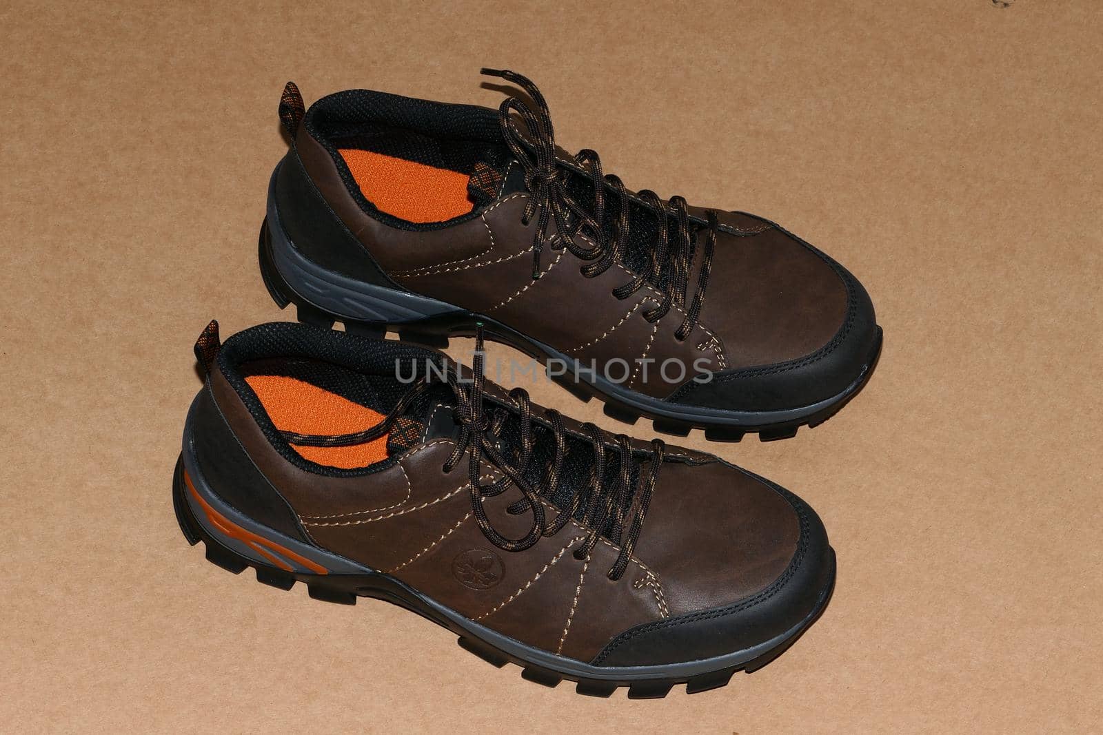 Shoes, men's brown shoes or new sneakers on a brown background. by Olga26