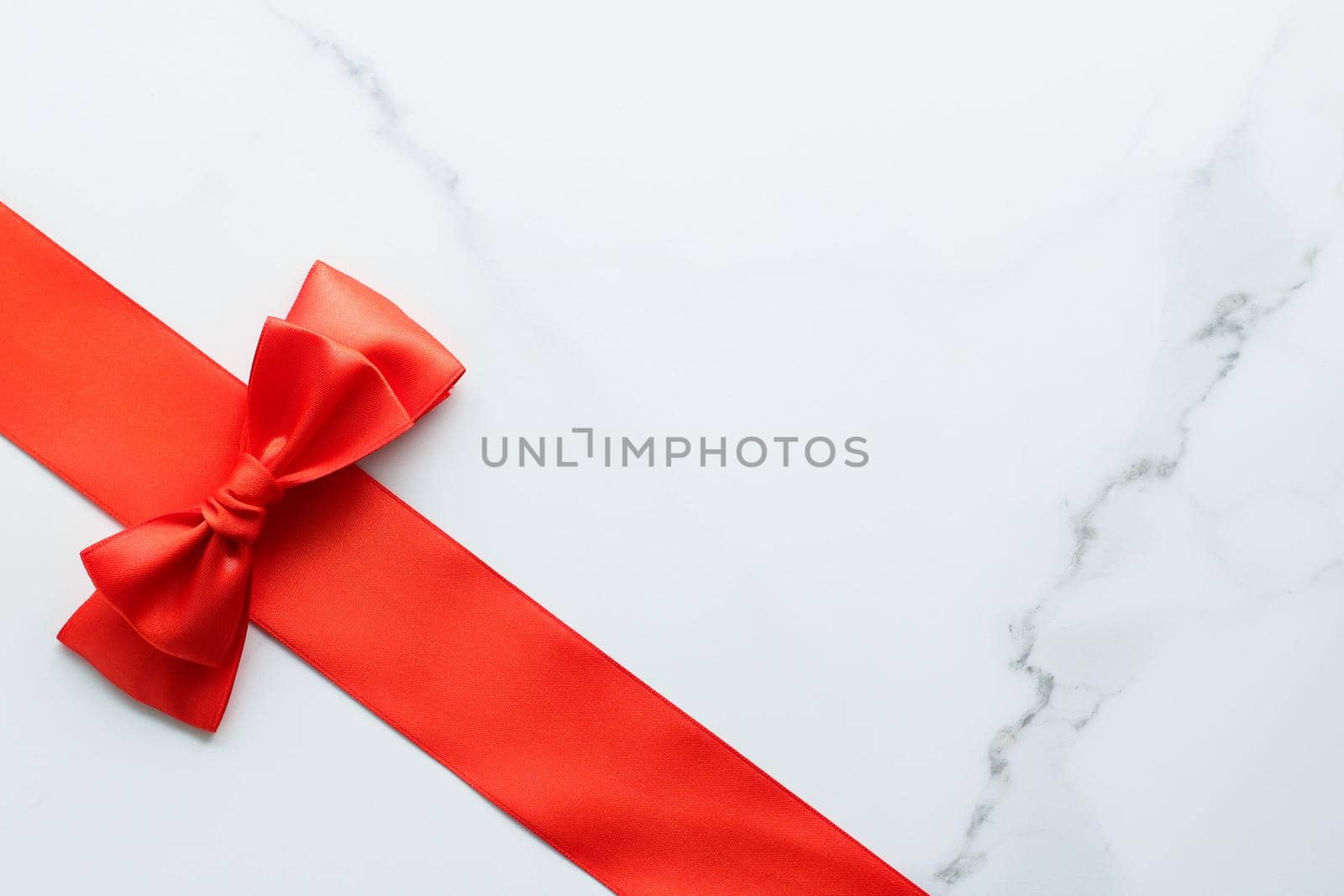 Holiday decor, feminine design and flatlay concept - Red silk ribbon on marble, top view