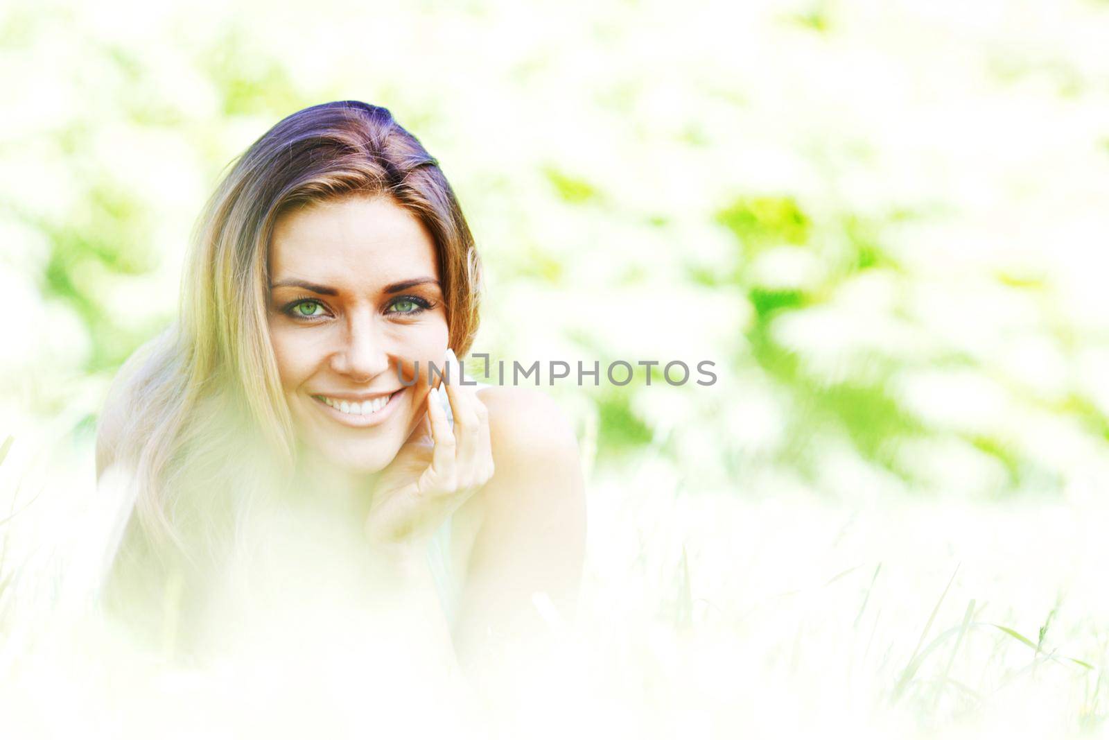 Portrait of attractive green eyes girl smiling in spring park nature background