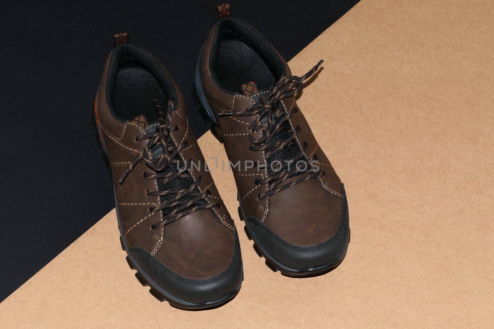 Men's shoes are stylish brown on a black-grey background. High quality photo