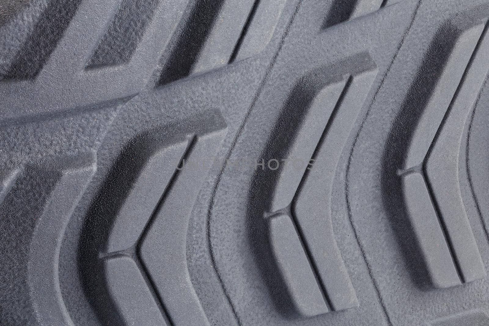 close-up full frame background of new generic contemporary sneakers outsole with protector shapes.