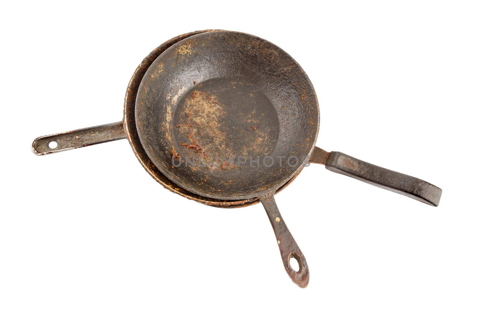old disgusting stained rusty cast iron pan stack with burnt fat and food leftovers isolated on white background