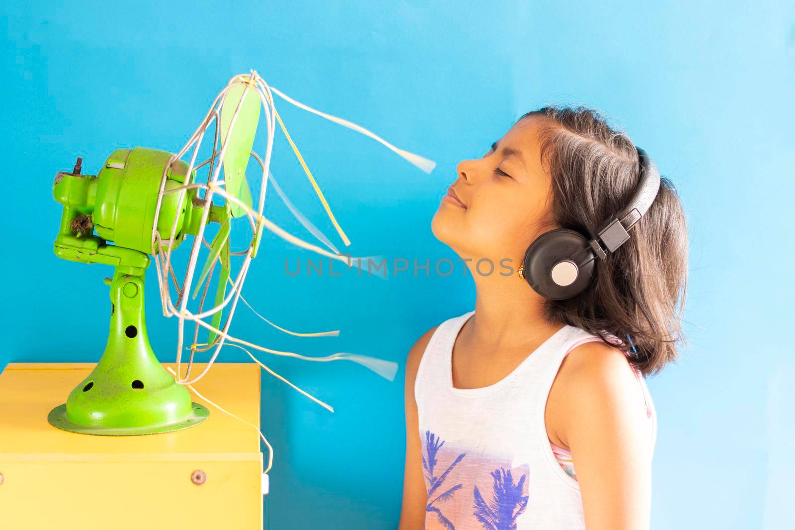 Beauty girl singing happily with her headphones with summer music