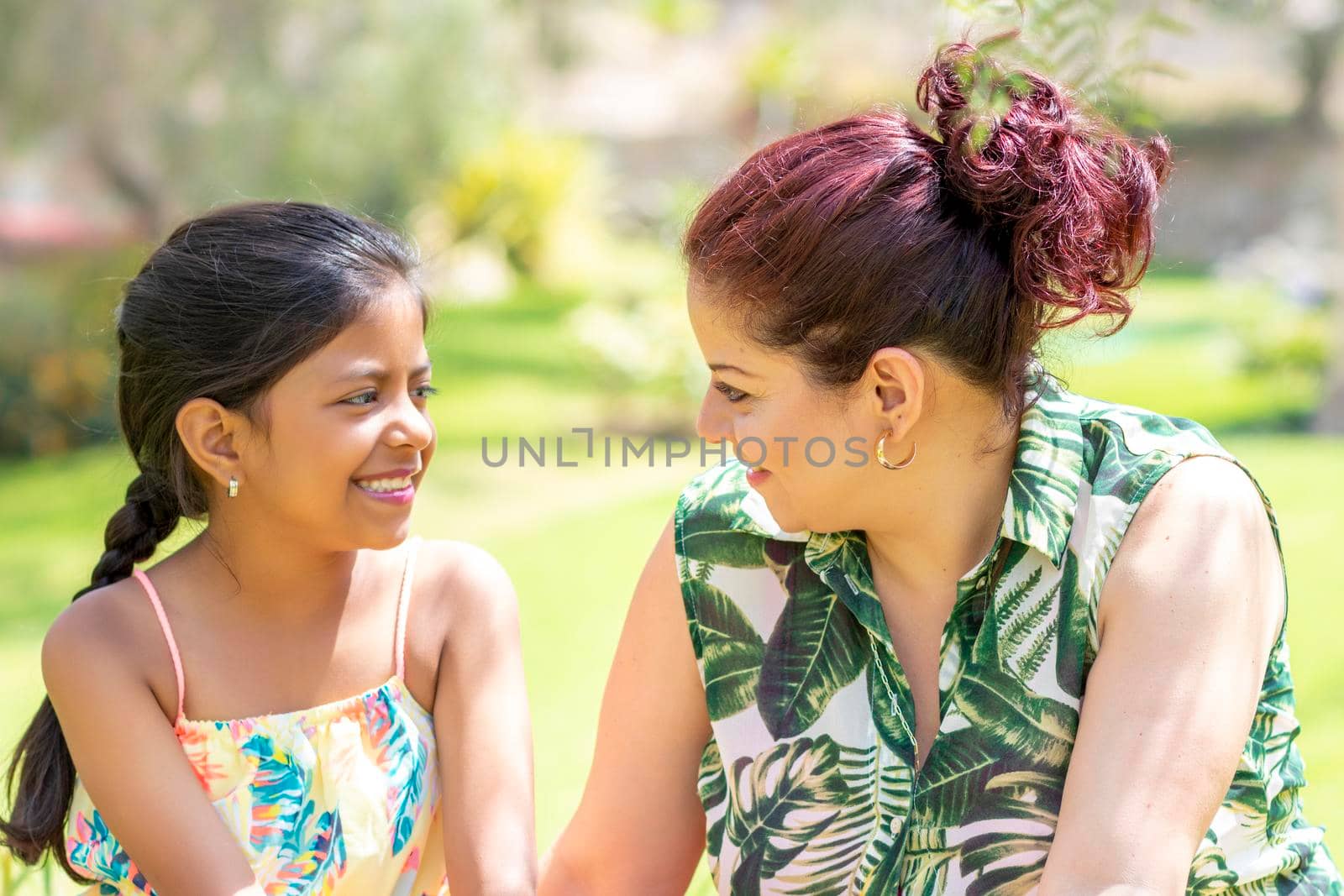 Love between a young mother and her pretty daughter outdoors