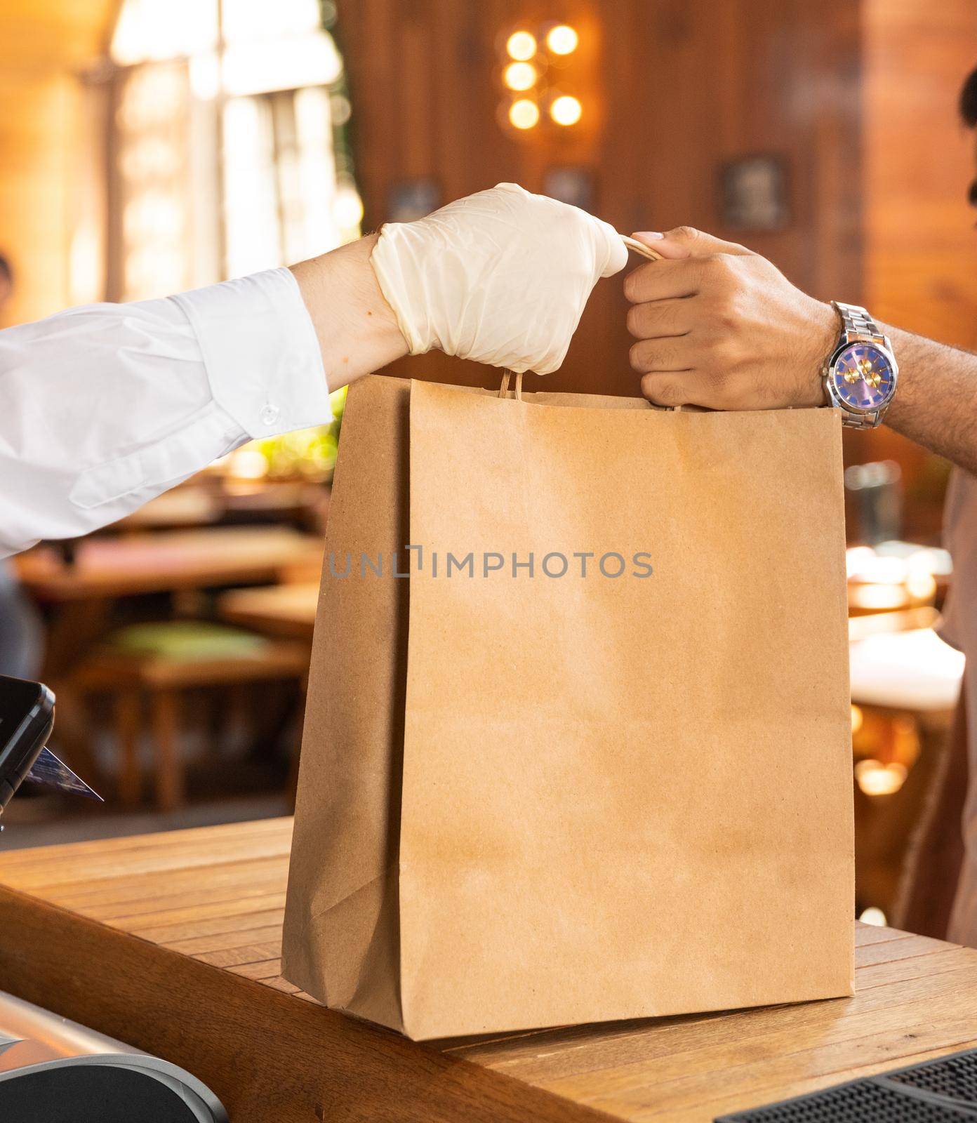Worker giving a ready food order bag to the client by ferhad