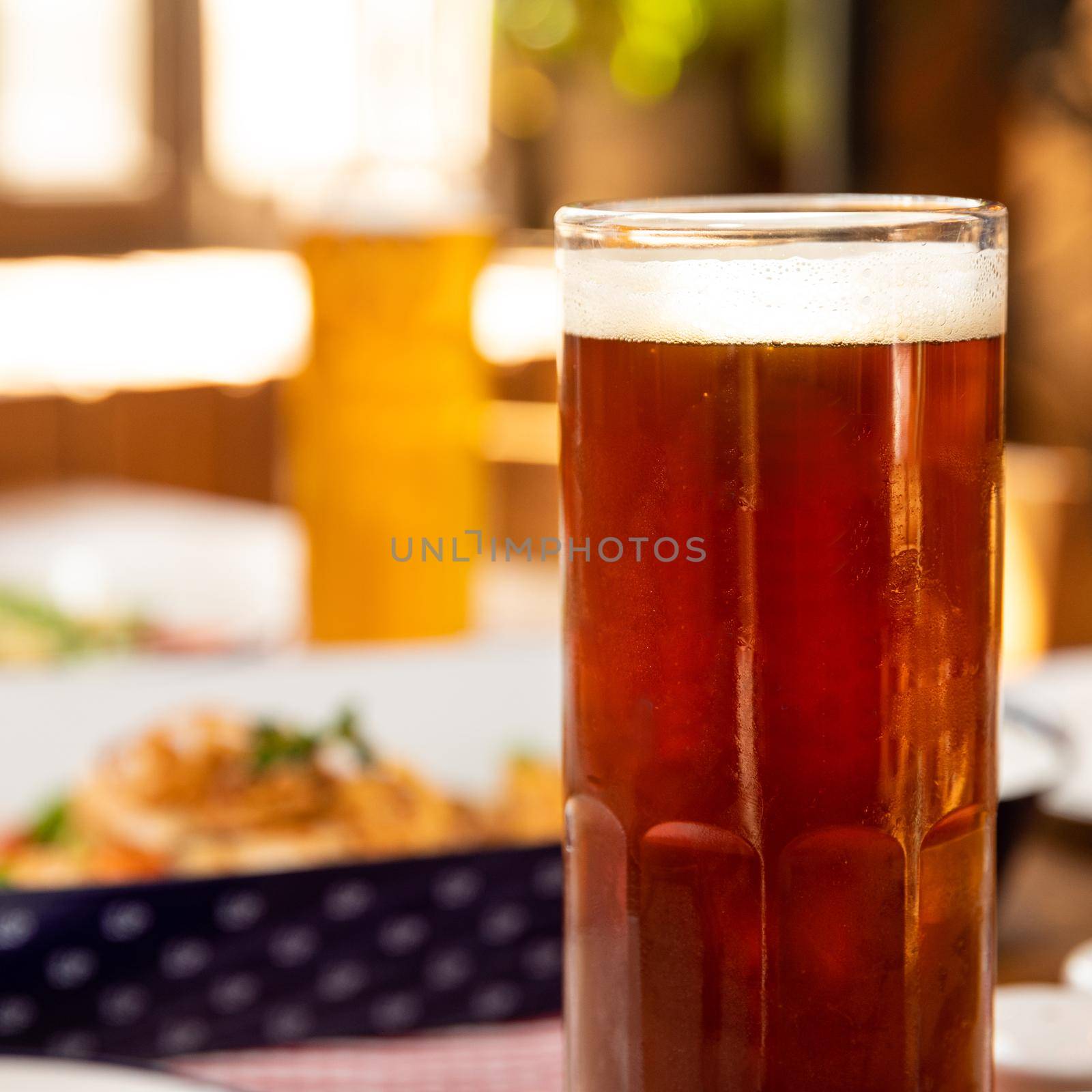 Dark beer glass with dish close up