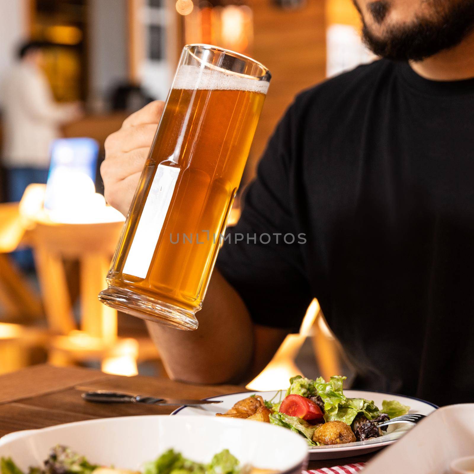 Man drinking beer with salad by ferhad