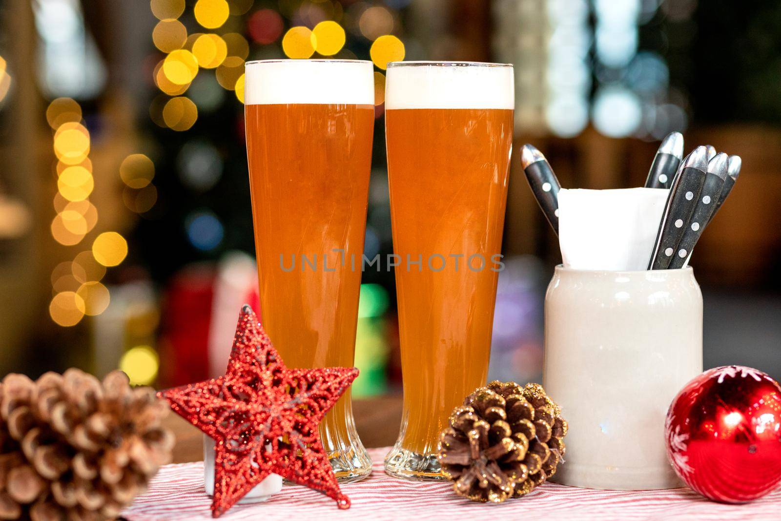 Beer drink glasses, mugs with christmas, new year toys, decorations, gifts with bokeh background by ferhad