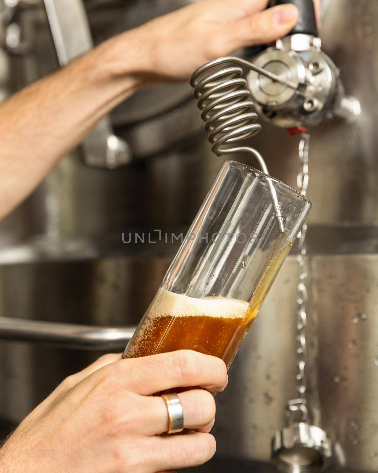 Man pouring, filling beer glass, mug from barrel