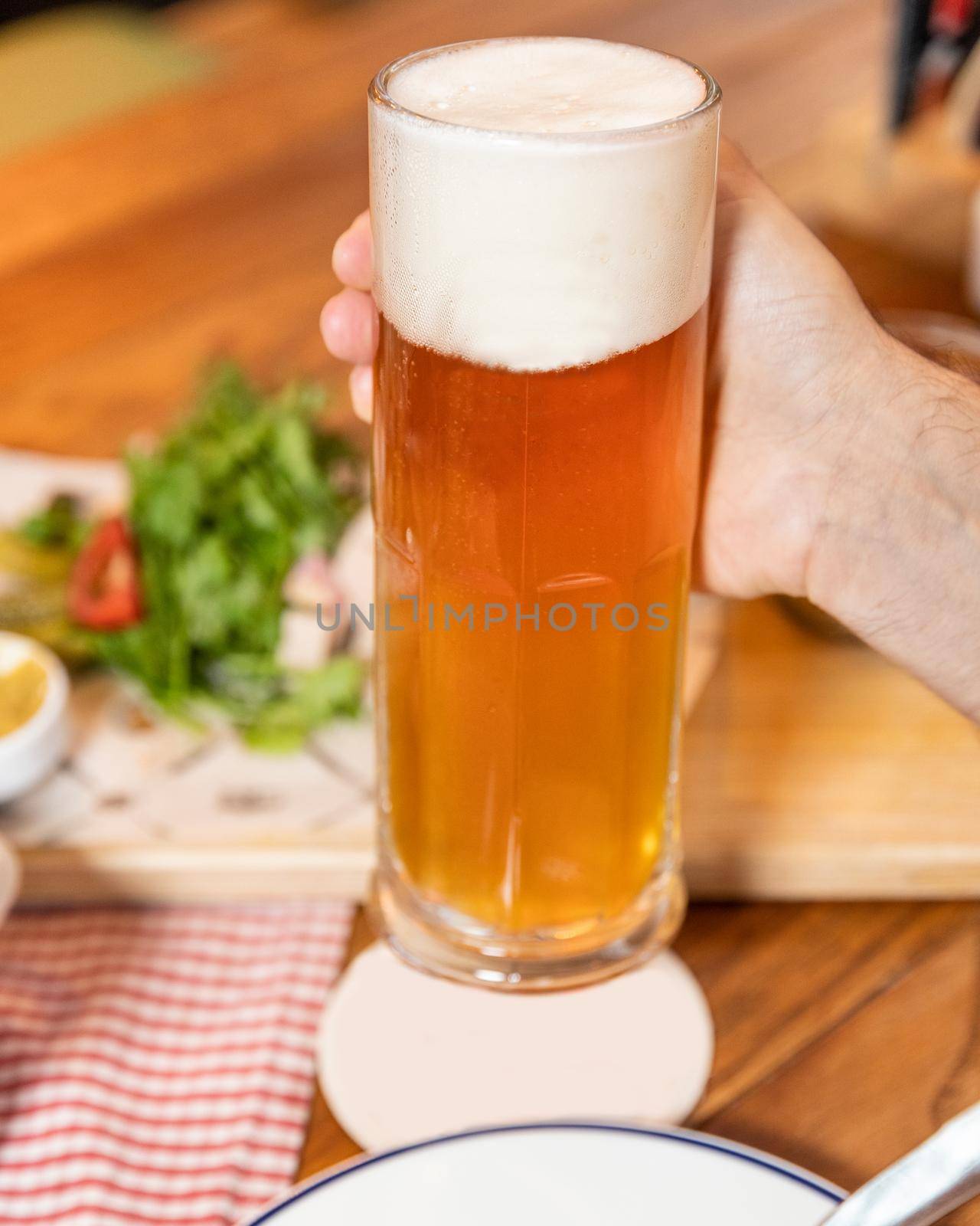 Holding beer drink mug glass, empty place for logo, name