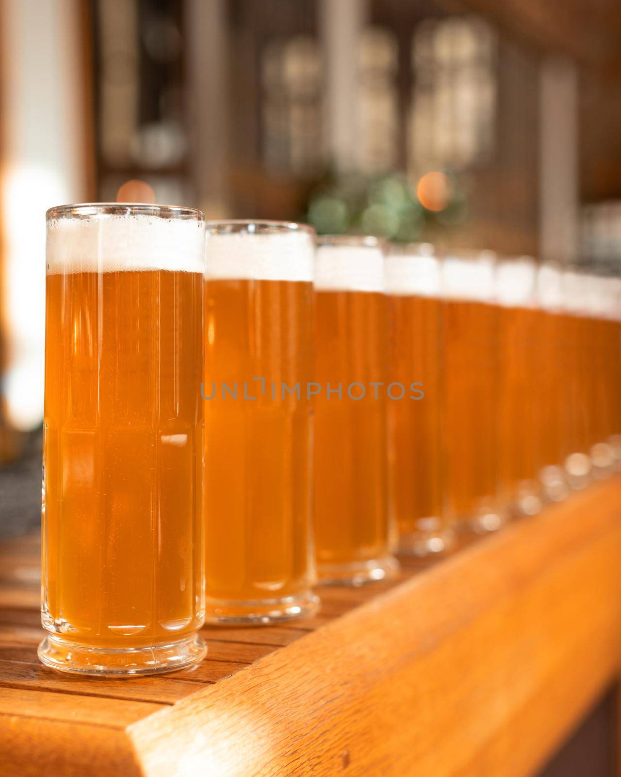 A lot of beer drink glasses side by side