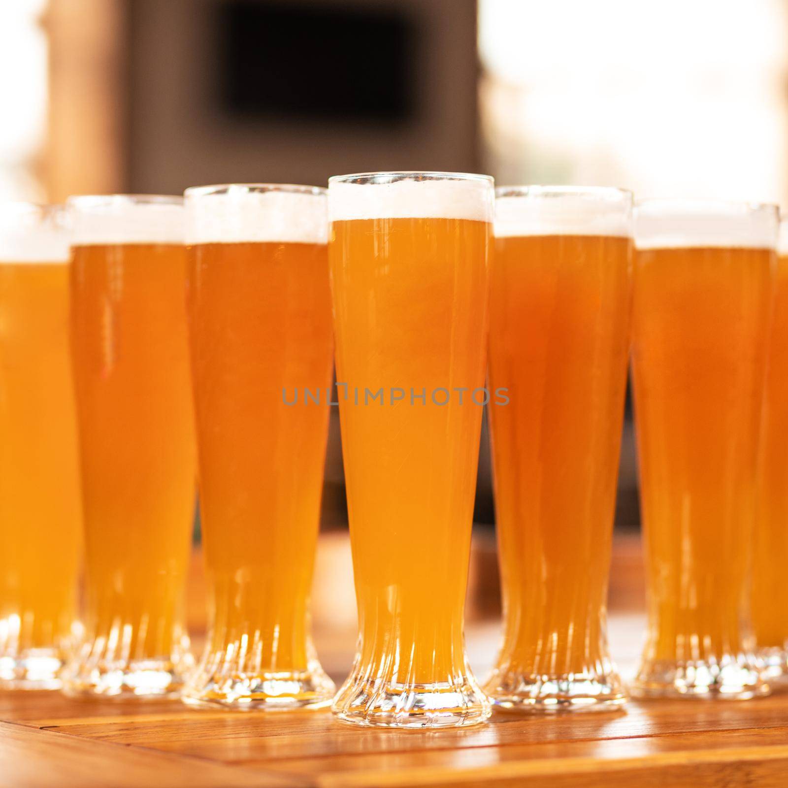 A lot of beer drink glasses, mugs on the table