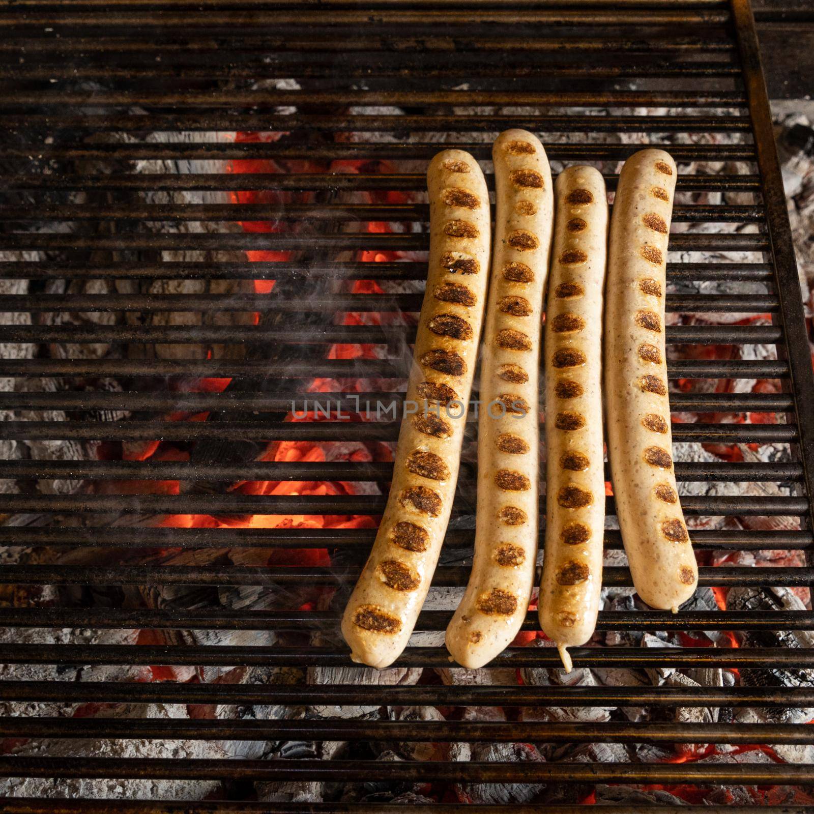 White German sausages cooking on charcoal, top view by ferhad