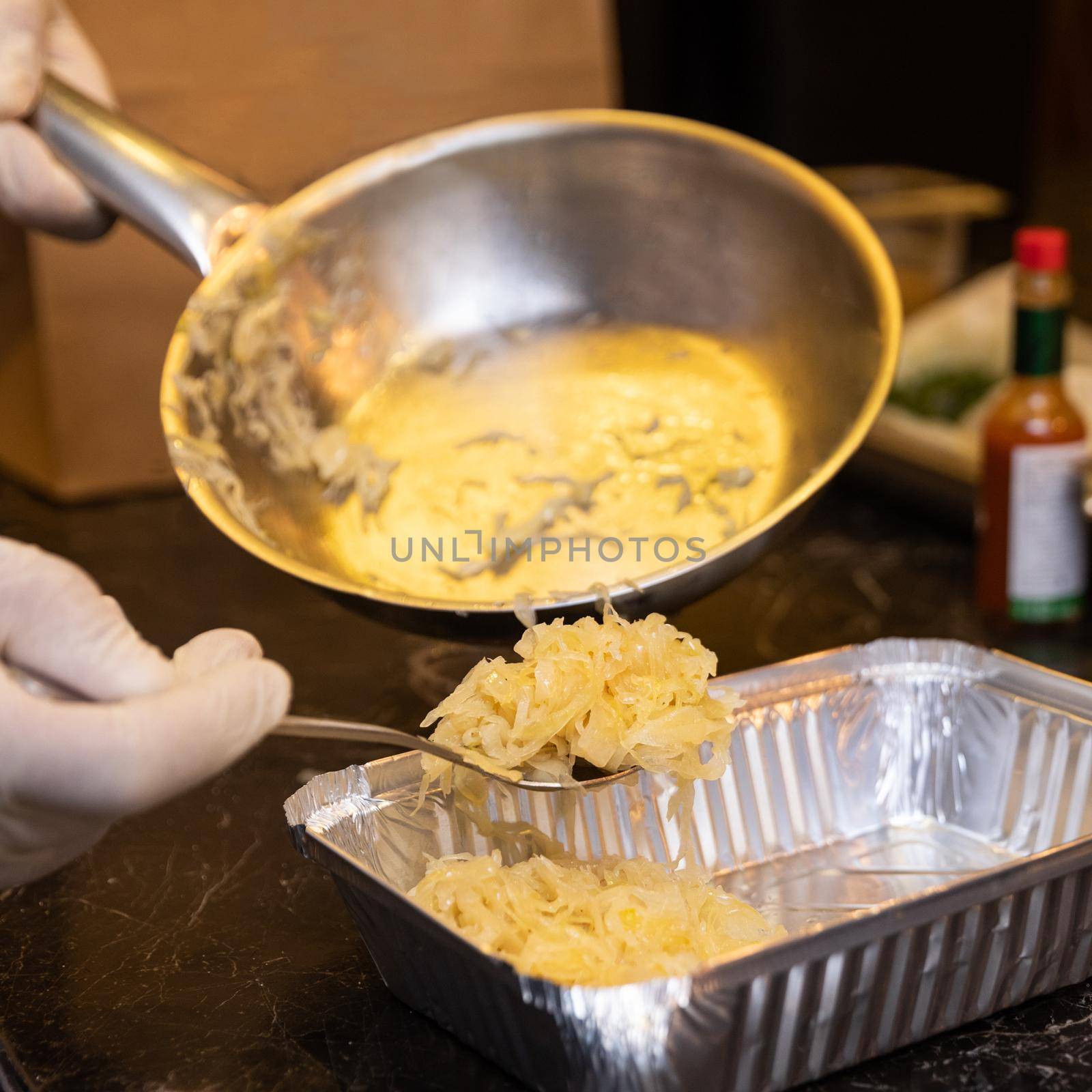 Chef putting fried onion to the box by ferhad