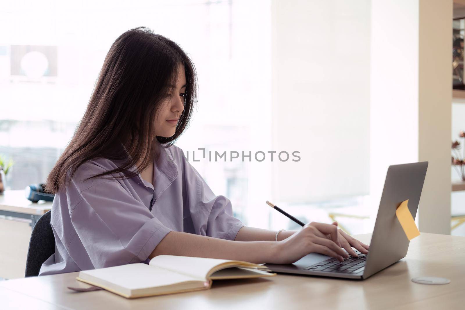 Online education. Asian girl online lesson using a computer video call to a virtual teacher at home by nateemee