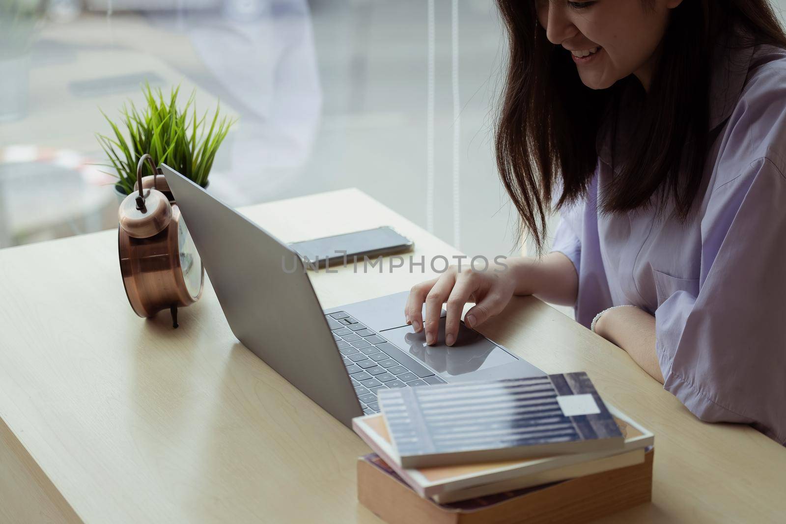 Online education. Asian girl online lesson using a computer video call to a virtual teacher at home by nateemee