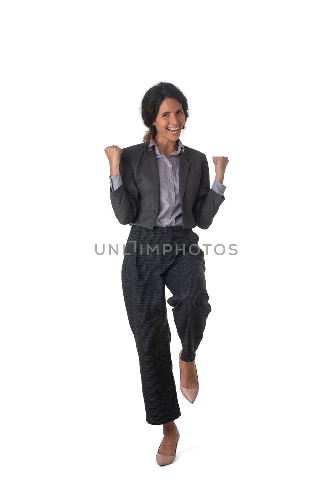 Full length portrait of young successful executive very excited, happy smiling business woman holding fists yes gesture, isolated on white background