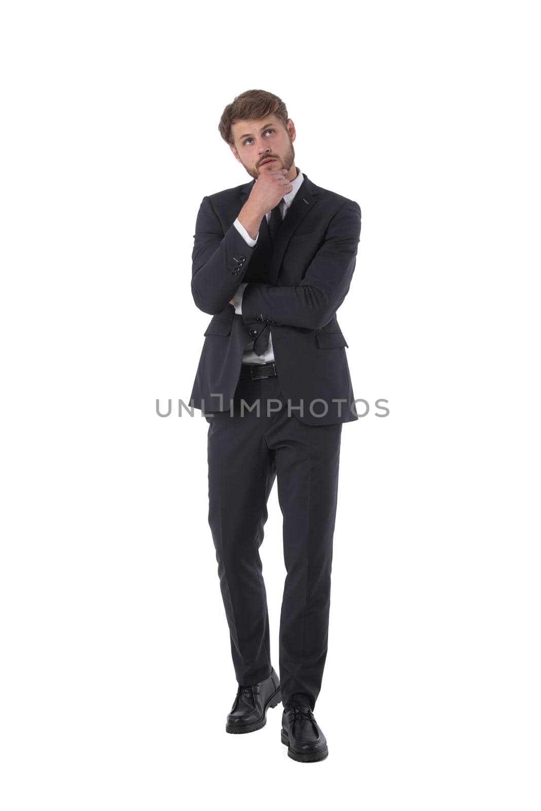 Full length portrait of pensive business man looking up holding hand to chin studio isolated on white background, business people