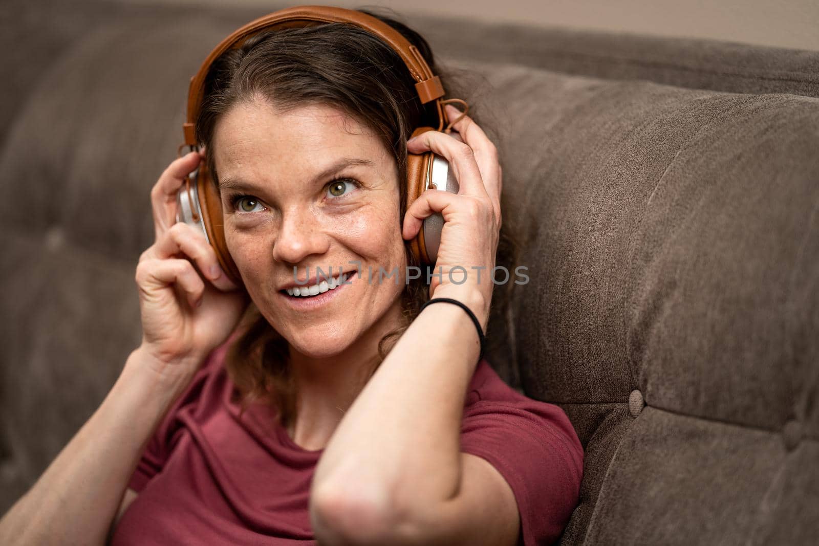 young woman enjoys music from wireless headphones.