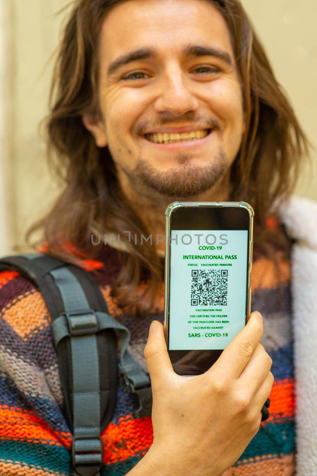 traveler with covid-19 online pass on smartphone app by verbano