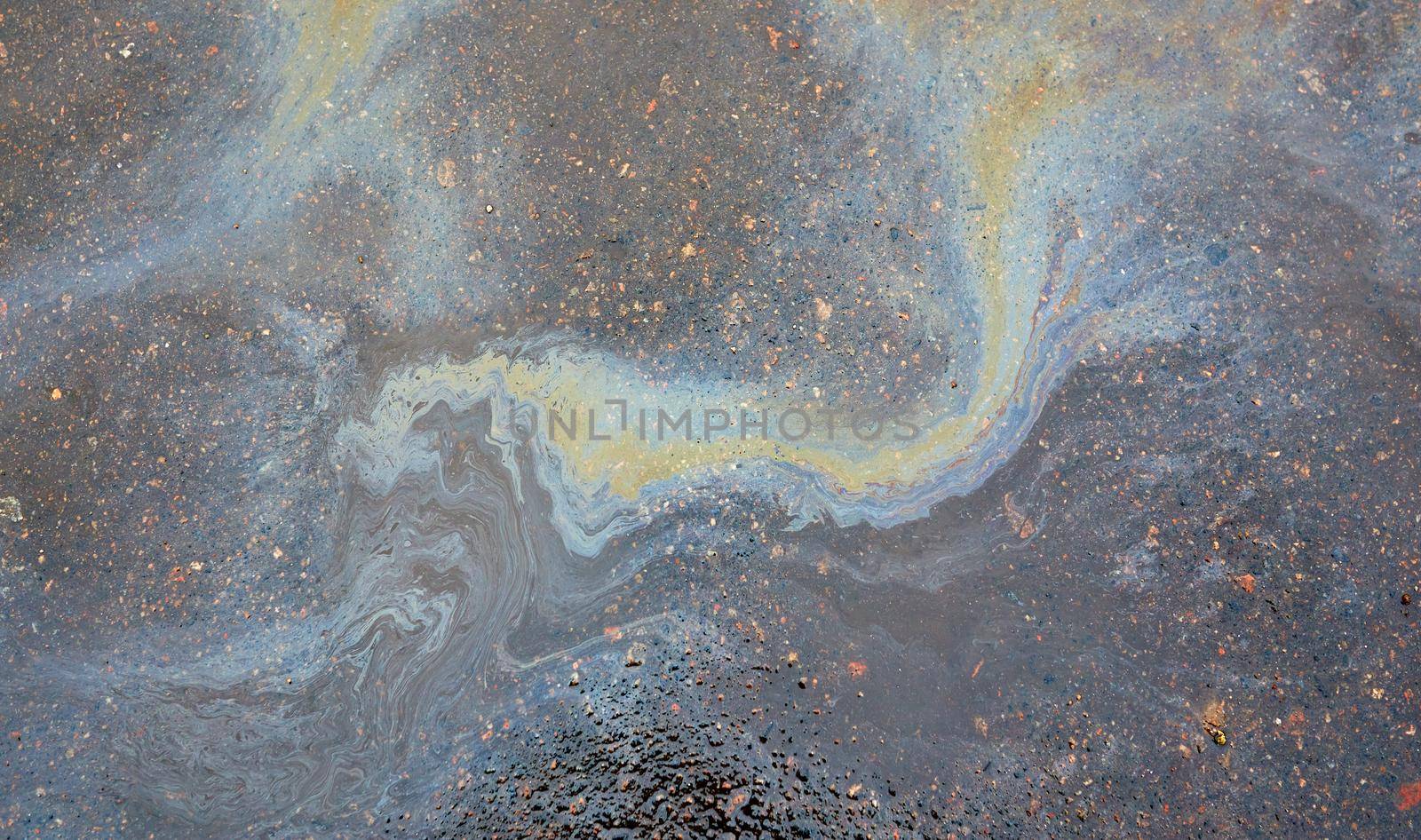 Oil stain on asphalt as texture or background.Environmental pollution concept.