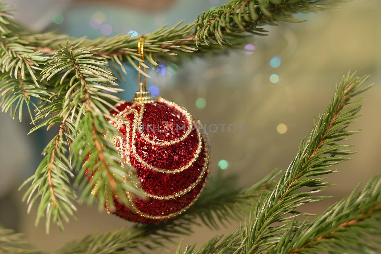 Cropped image of christmas tree with red toy. Soft selective focus