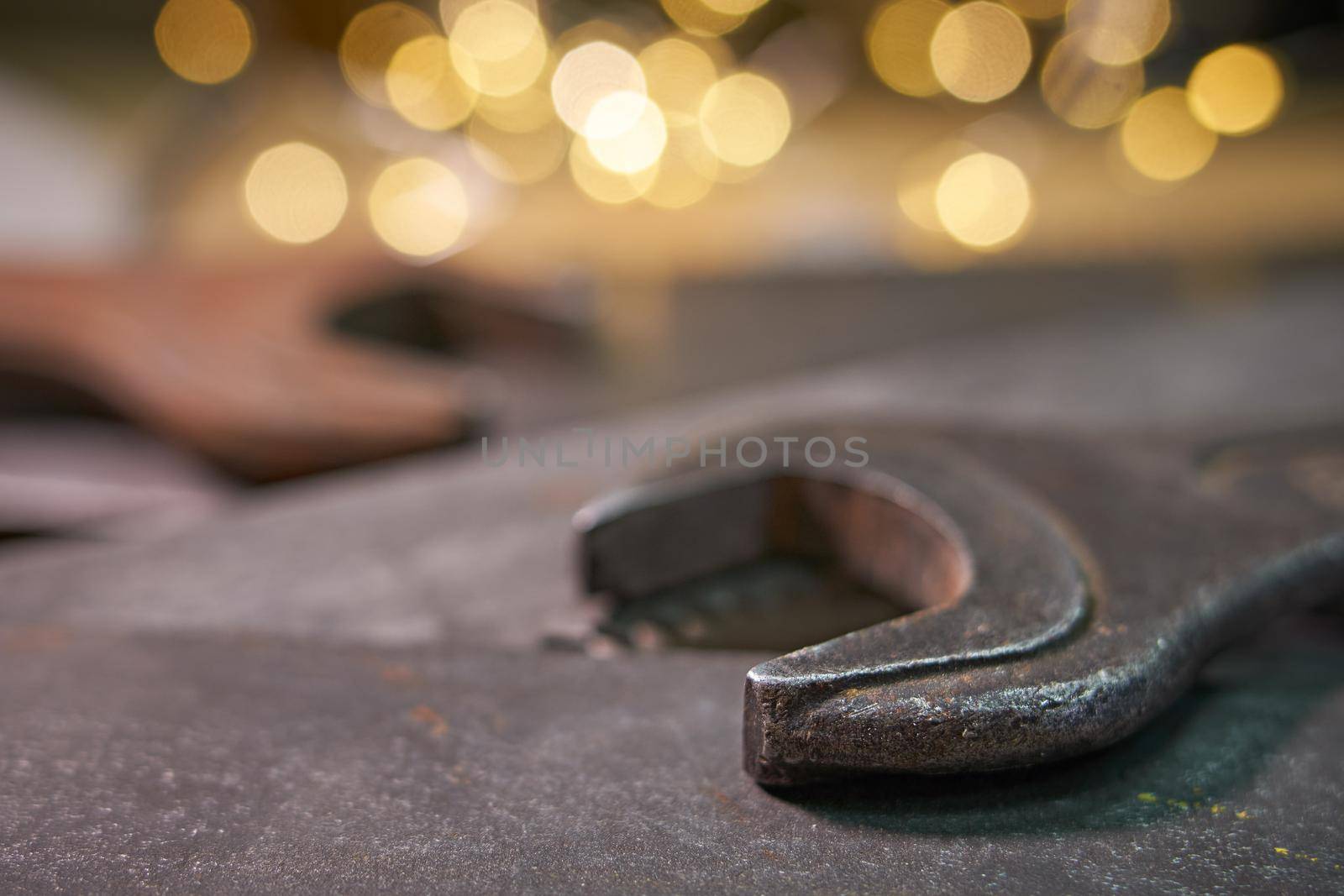 wrenches and hacksaw blades lie on a metal sheet.Soft selective focus