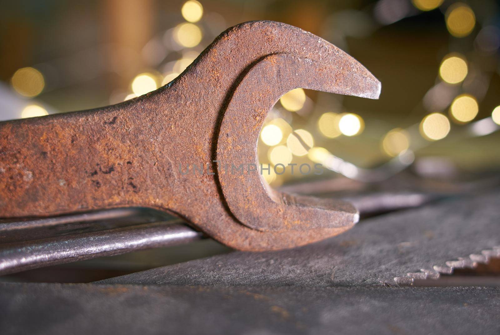 wrenches and hacksaw blades lie on a metal sheet.Soft selective focus