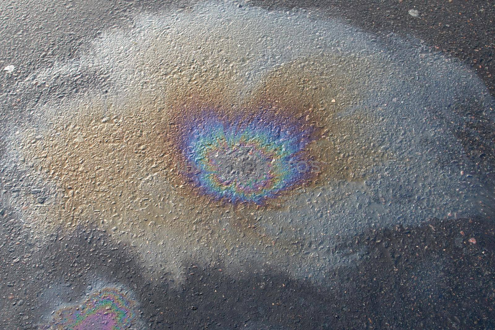 Beautiful abstract colorful background, texture, stains from engine oil on the asphalt.Colorful gas stain on wet asphalt