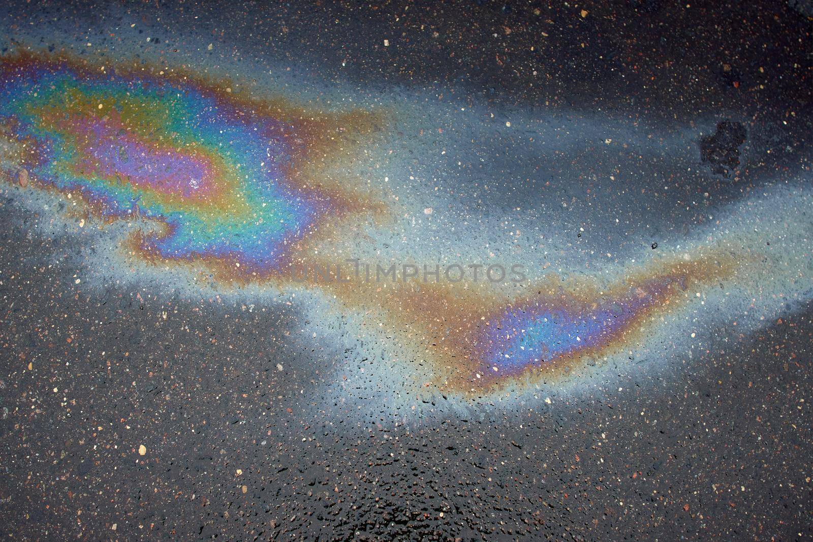 Beautiful abstract colorful background, texture, stains from engine oil on the asphalt.Colorful gas stain on wet asphalt.