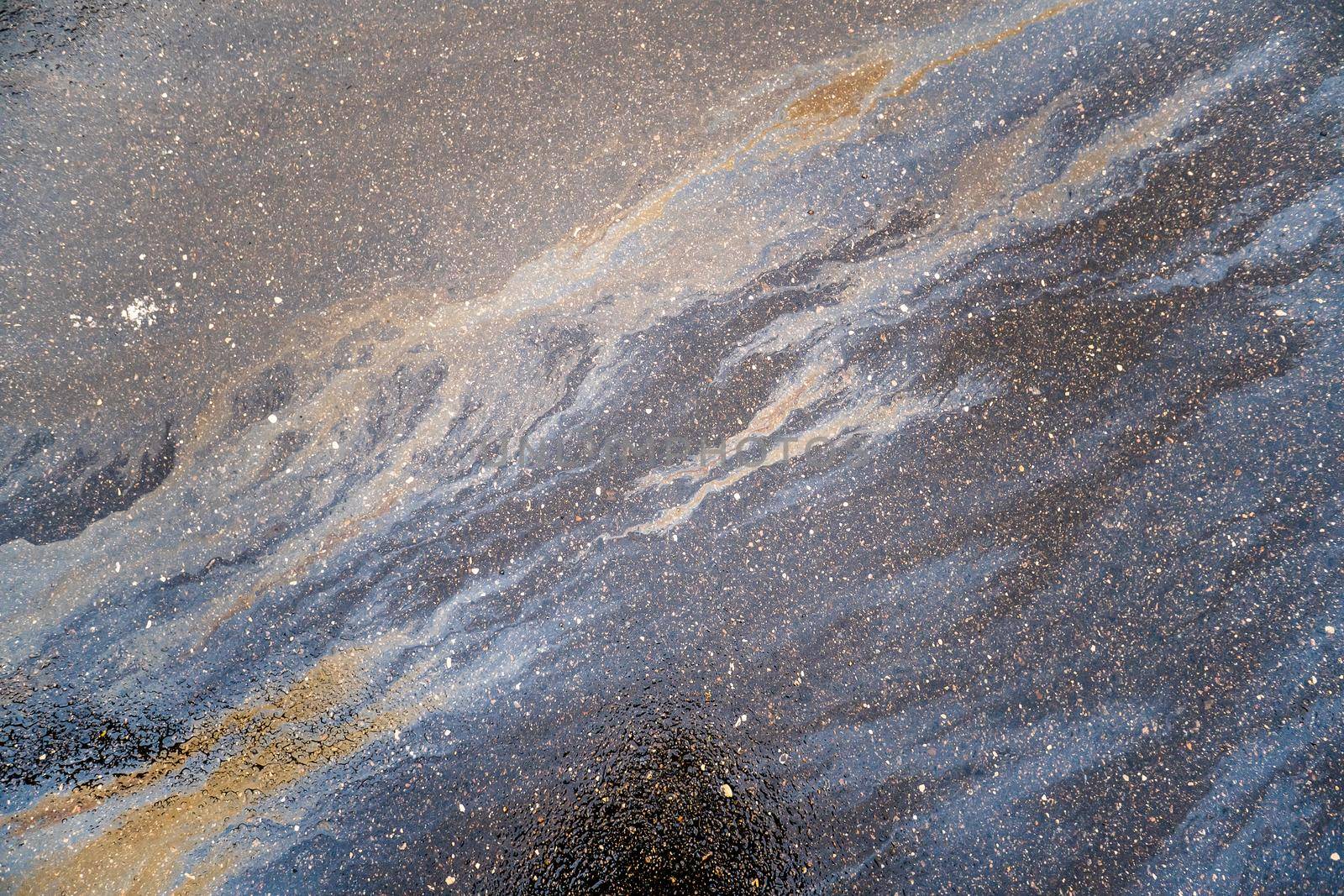 Beautiful abstract colorful background, texture, stains from engine oil on the asphalt.Colorful gas stain on wet asphalt.