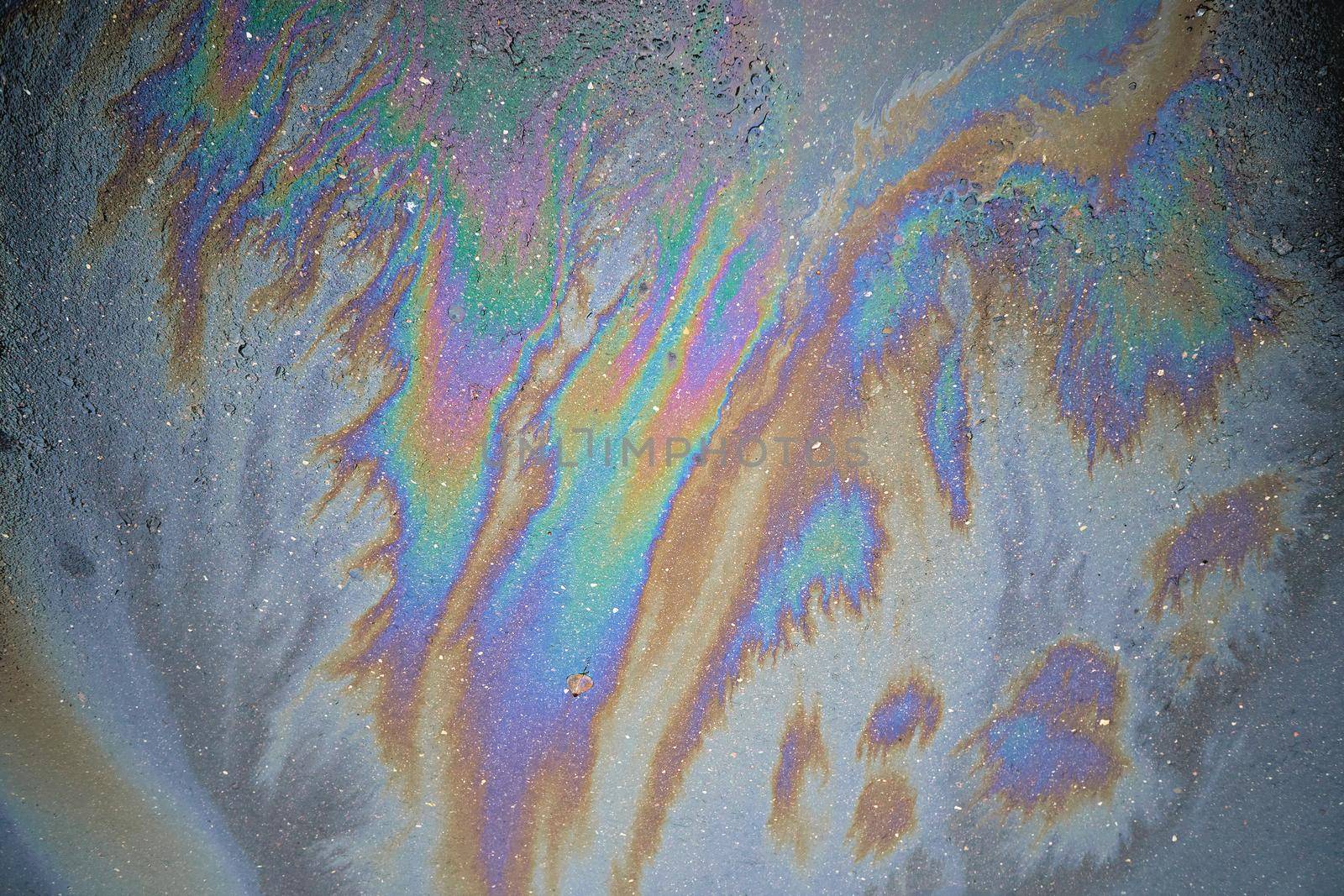 Beautiful abstract colorful background, texture, stains from engine oil on the asphalt.Colorful gas stain on wet asphalt