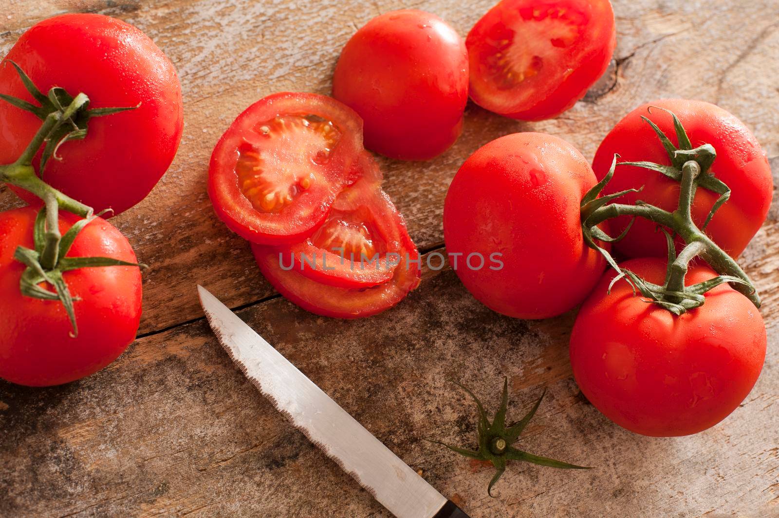 High-angle view of tomatoes on rustic wooden table by stockarch