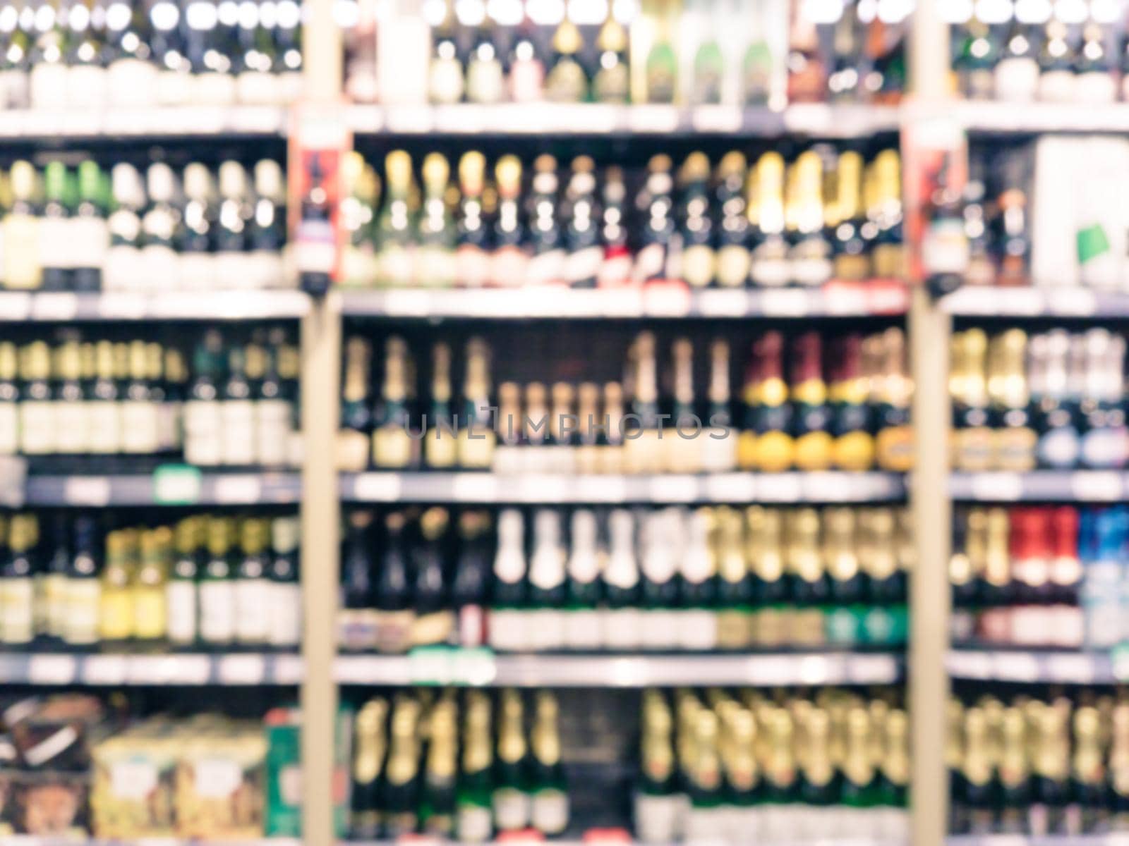 Blurred colorful supermarket products on shelves - background with shallow DOF