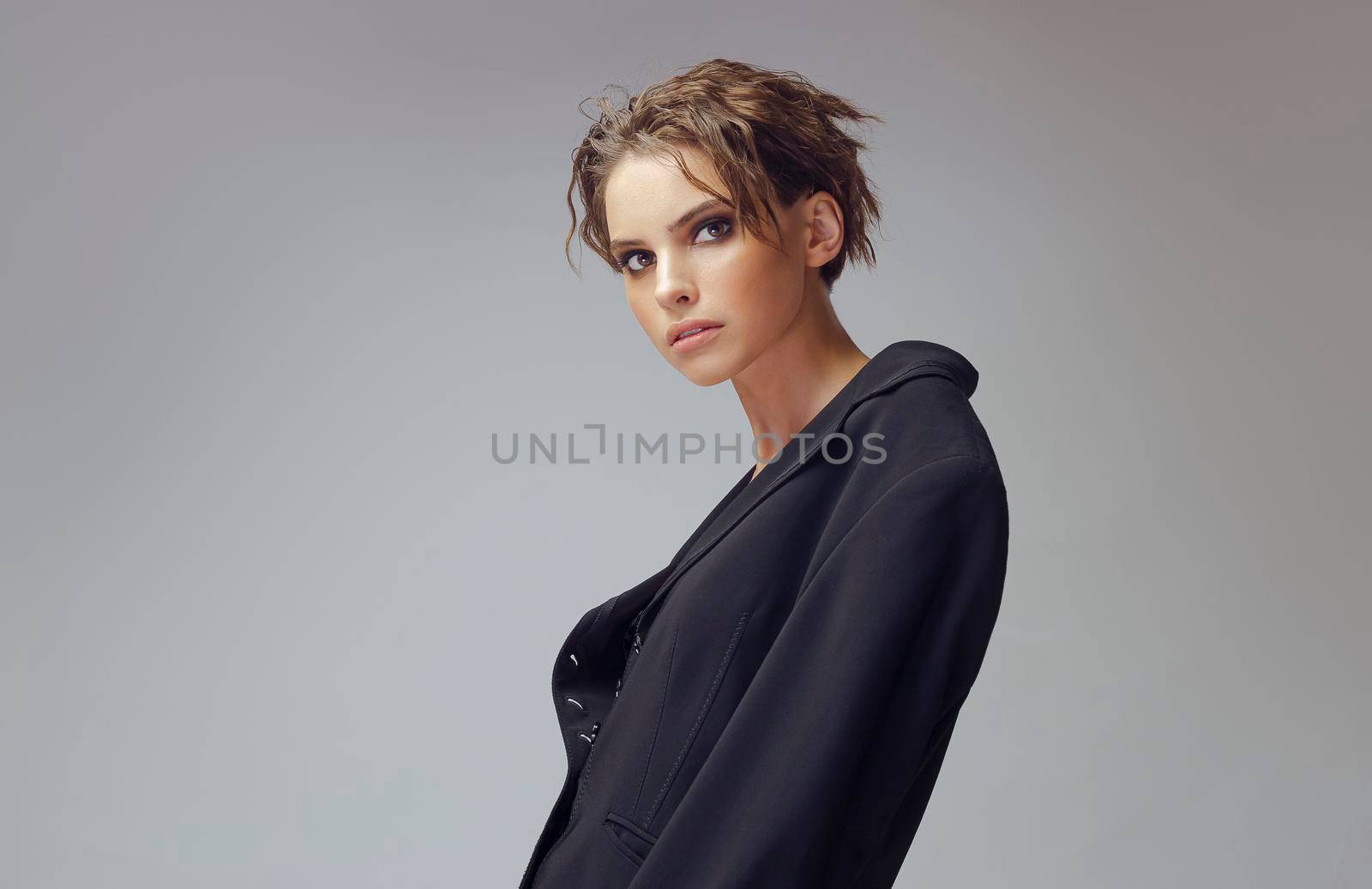 Beautiful stylish woman wearing black jacket. Fashionable and self-confident girl. Clothing, style and fashion