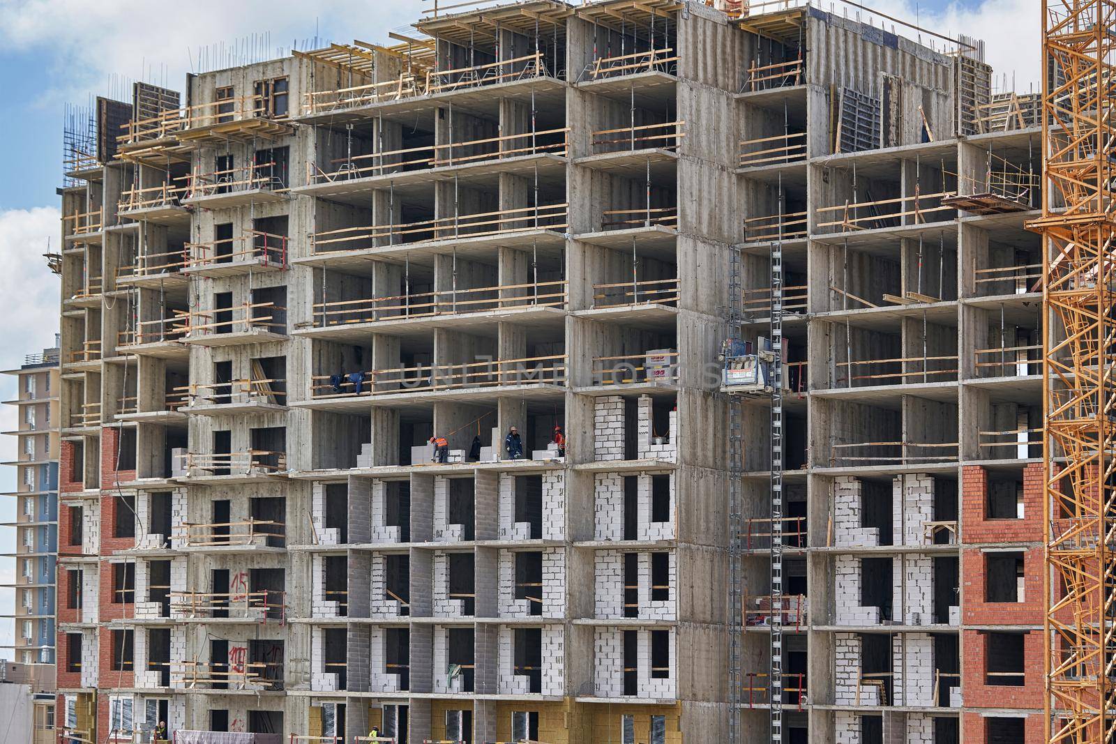 High rise building under construction, empty premises without a front wall by vizland