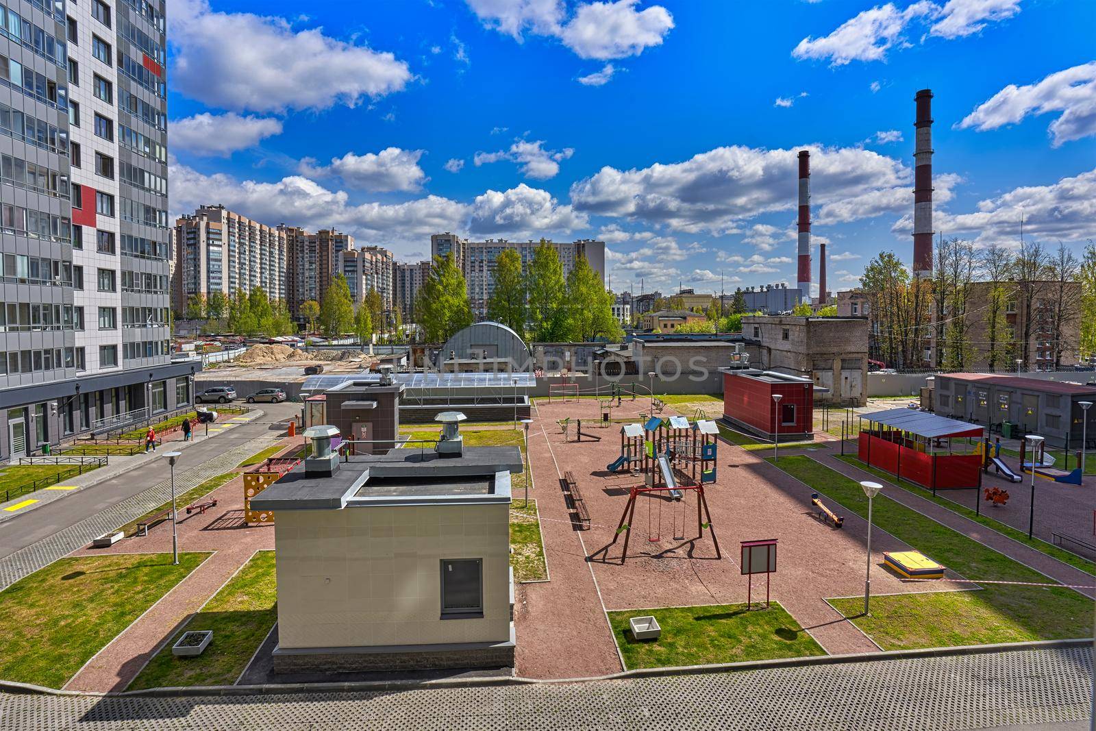 View of the playground in the courtyard of the condominium residential building by vizland