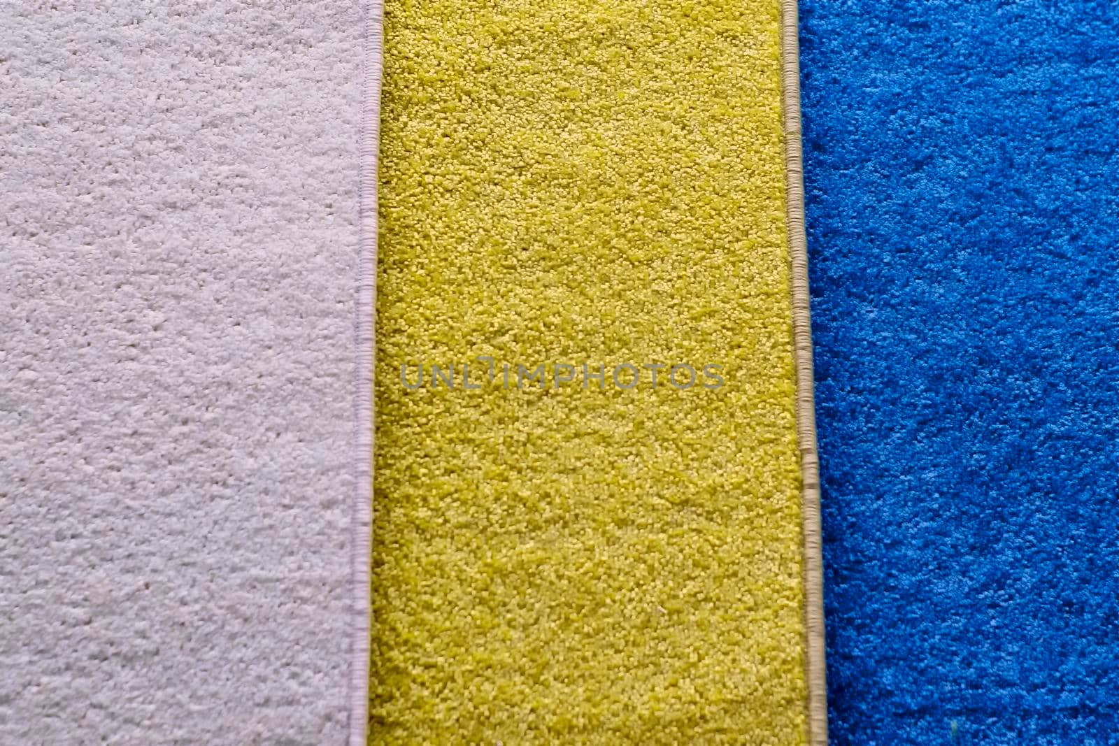 Textile pile mats of different colors. Front view, indoors horizontal shot. by Essffes