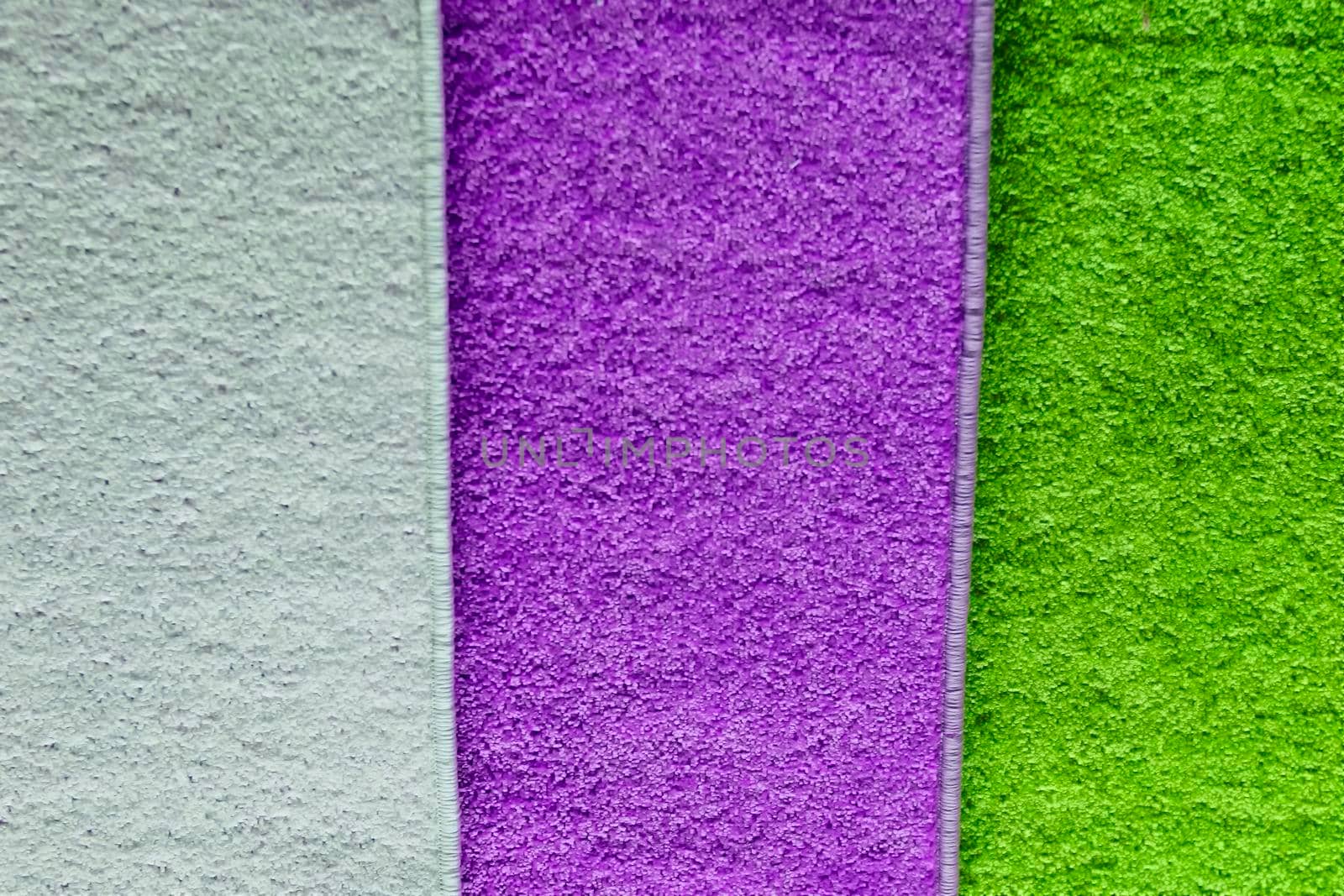 Textile pile mats of different colors. Front view, indoors horizontal shot. by Essffes