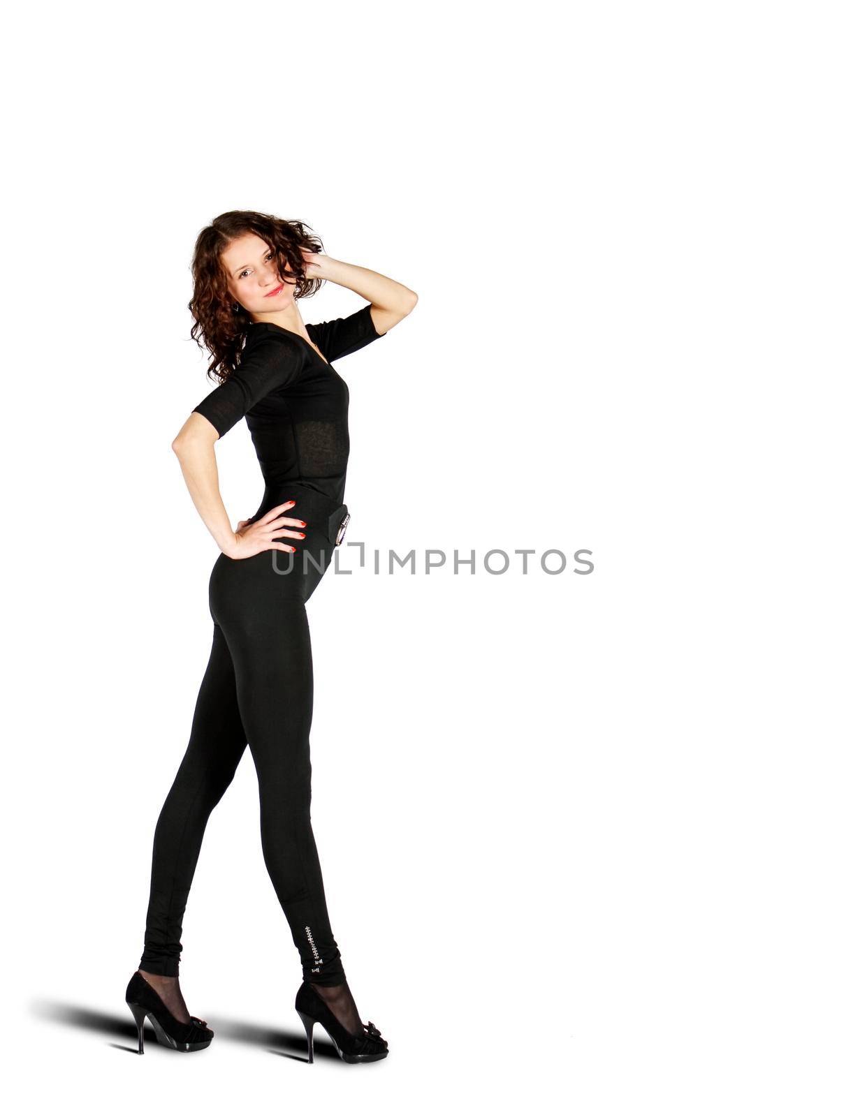 young girl in black suit posing standing in the studio on white bacground