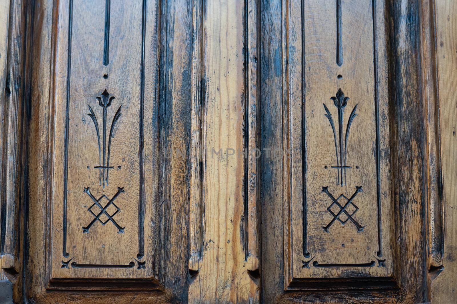 Antique wooden door with inscriptions seen by madrid