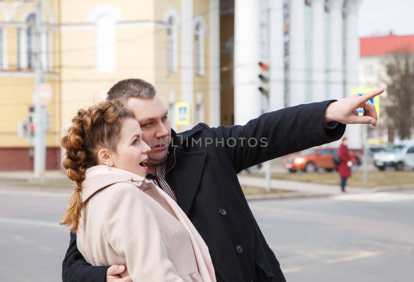 married couple walking along a city street on spring day