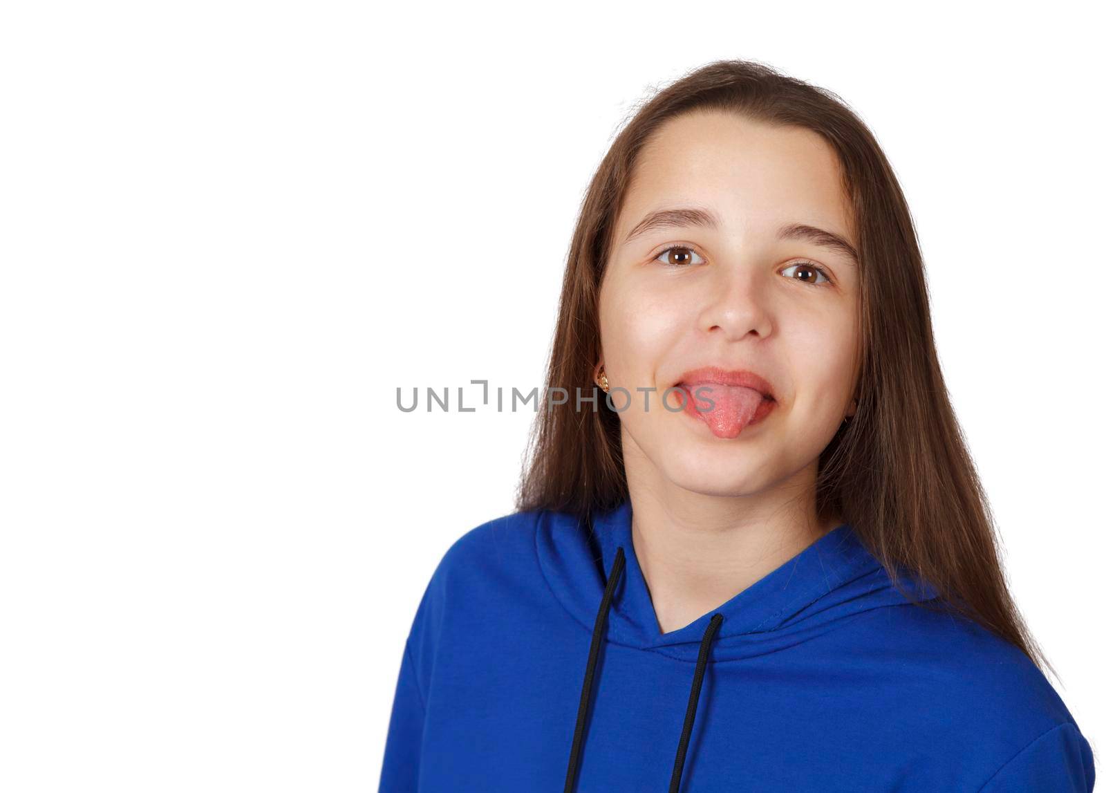 teen girl showing tongue in studio on white background