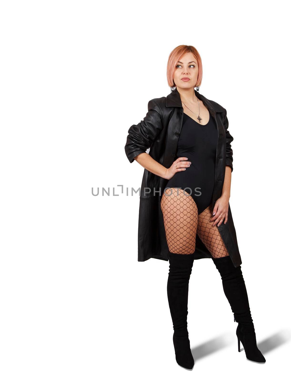 woman in leather coat, mesh tights and boots posing standing by raddnatt