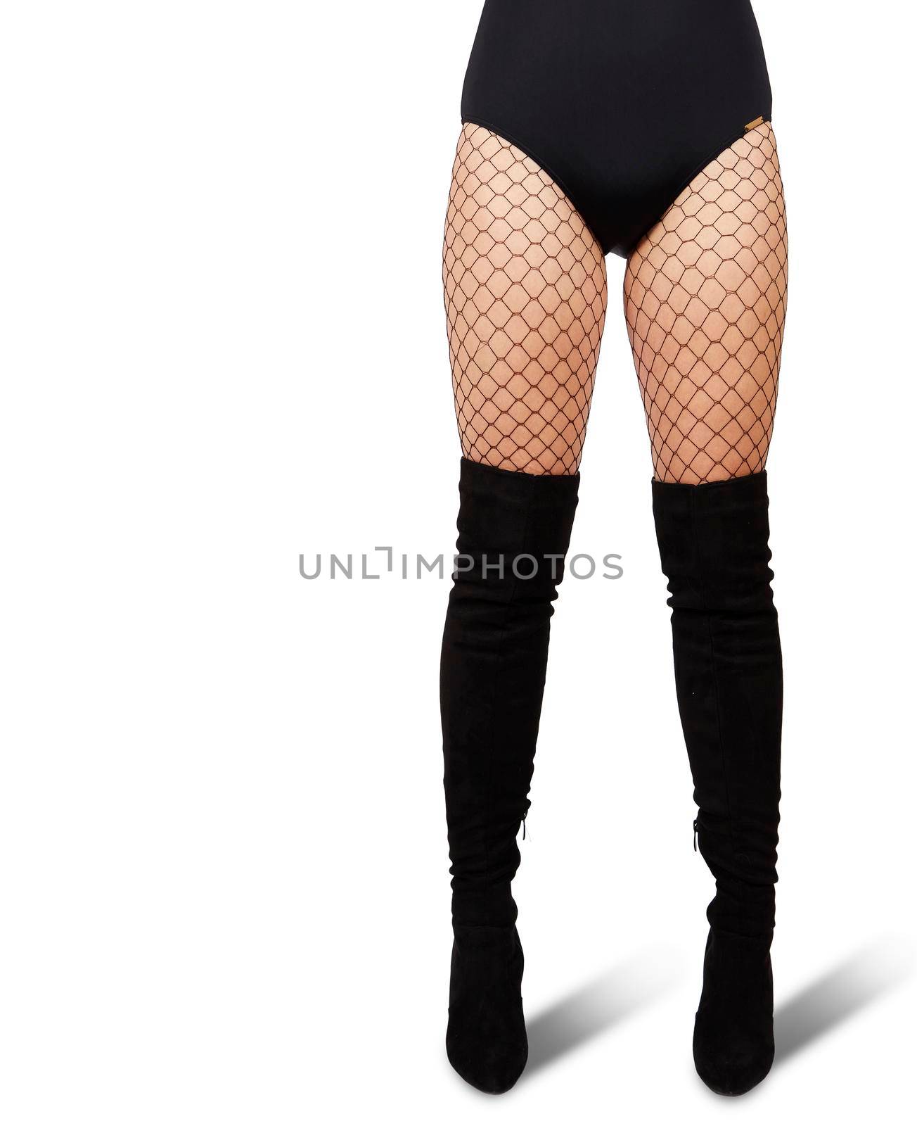 slender female legs in mesh tights and black boots on white background