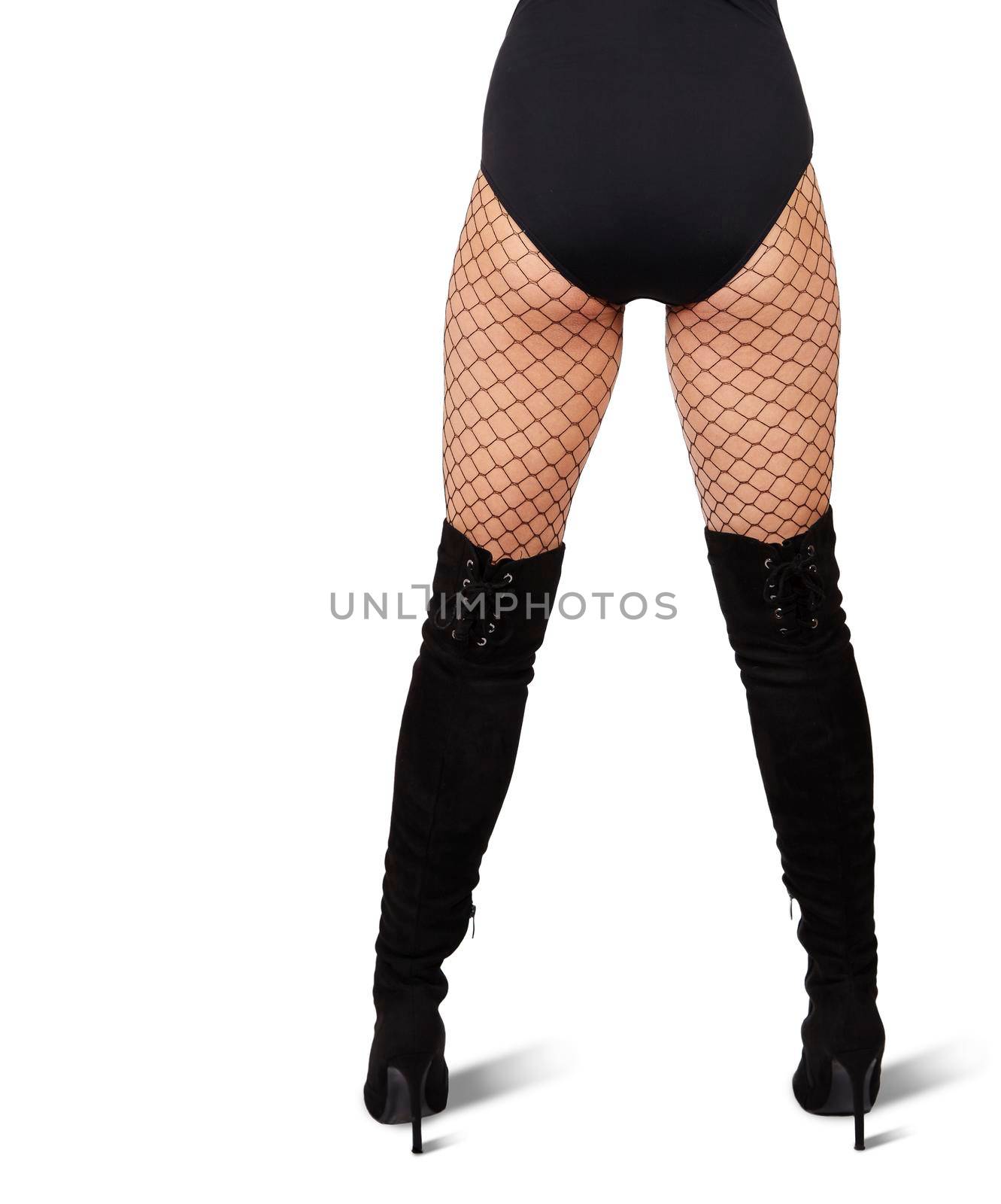 slender female legs in mesh tights and black boots on white background. back view
