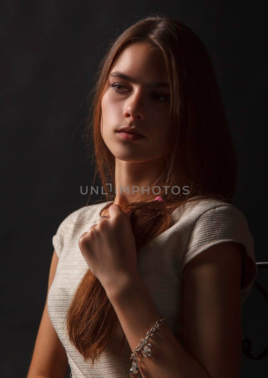 portrait of a young beautiful girl in studio on a black background